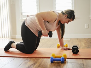 Woman Using Exercise Weights in a Home