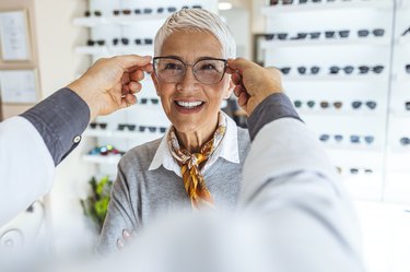 an older adult being fitted for new glasses, to represent vision changes with age