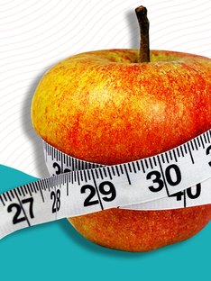 A tape measure wrapped around an apple on a colorful background