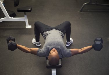 man doing a dumbbell upper body superset workout
