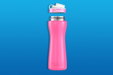 a pink cirkul water bottle isolated on a blue gradient background
