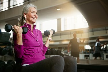 Menopausal woman doing strength training workout in the gym