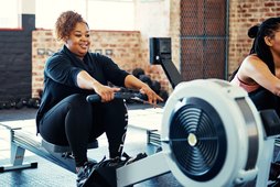 Woman doing a cardio workout on the rowing machine at her gym