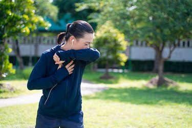 Woman sneezing after exercise outside